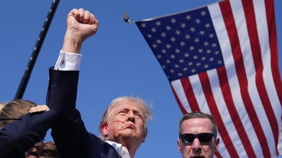 Trump raising his fist after being shot